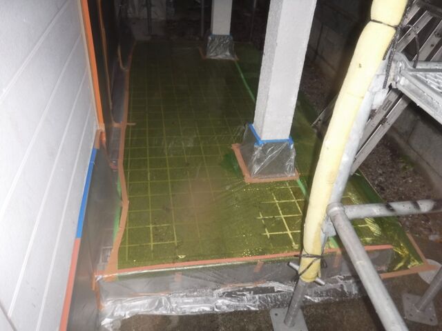 塗装に備えてビニールで養生した玄関床と柱の根元
